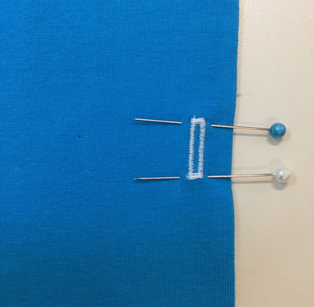 Place pins to protect the buttonhole